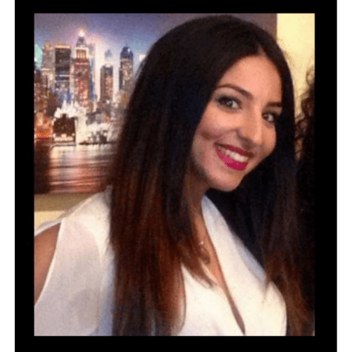 dark haired woman smiling to camera