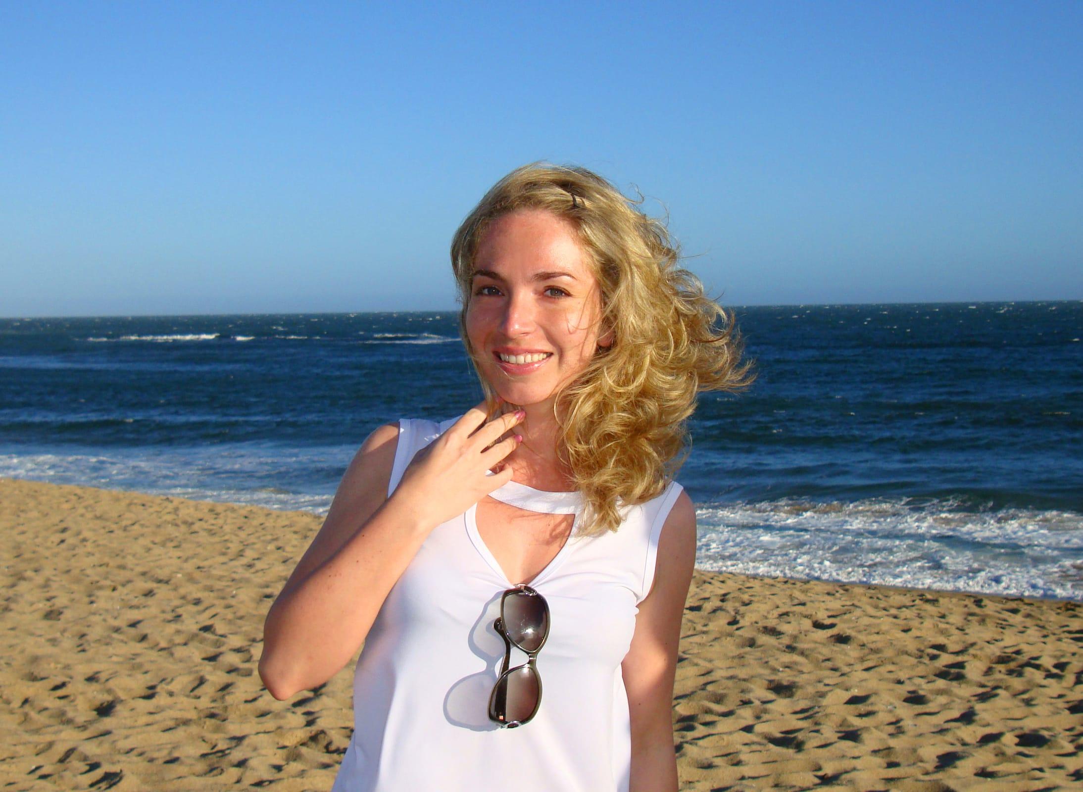 blonde woman smiling on beach