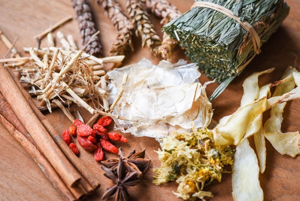 dried herbs on wooden table