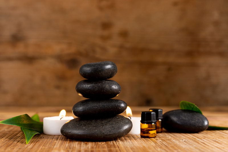 stacked spa stones with lit candles