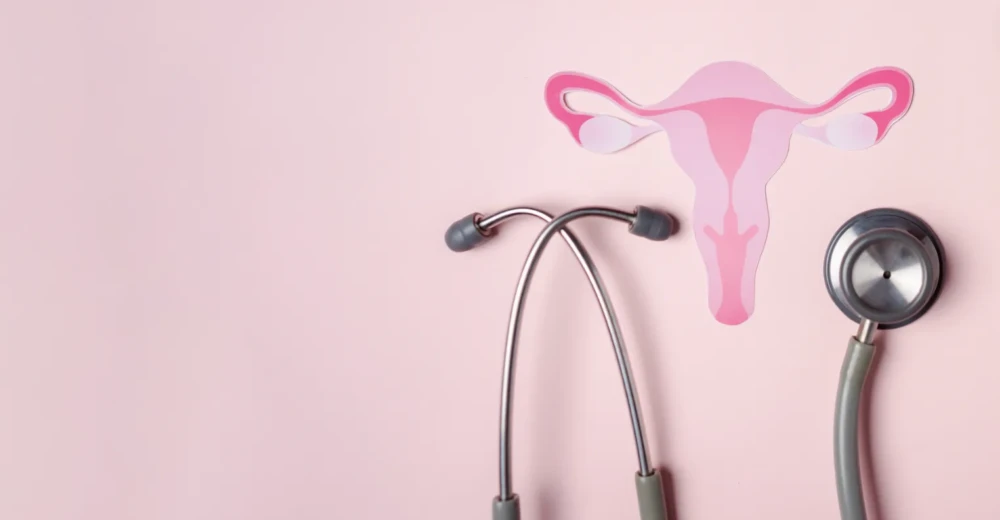 Stethoscope next to illustration of female reproductive system symbolizing naturopathic PCOS treatment and reproductive hormone support.